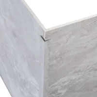 Close-up of an L-shaped metal bracket securing two marble-patterned panels at a corner joint.