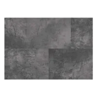 Close-up of textured dark gray concrete surface with a patchwork pattern of varying shades and roughness