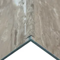 Close-up of marble corner trim detail with beige and gray stone patterns and metal edge support.