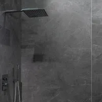 Modern bathroom shower with large square rainfall showerhead and dark gray marble wall tiles
