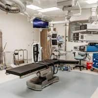 a room with machines and equipment with Emergency department in the background