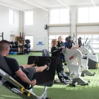 a group of people exercising in a gym