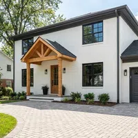 Before and after home exterior transformation with beige siding changed to white brick and new wooden porch structure.