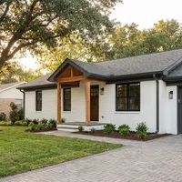 Side-by-side before and after photos of a house remodel showing updated exterior with bricks and new landscaping.