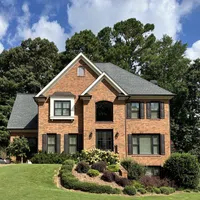 a brick house with a lawn in front of it