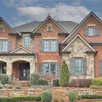 a large brick building with a garden in front of it