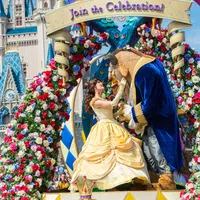 Beauty and the Beast characters on floral-decorated float at Disney Festival of Fantasy parade