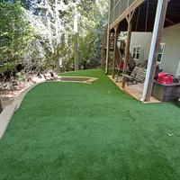 a lawn with a building in the background