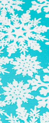 Various white paper snowflakes arranged on a bright blue background, showcasing intricate winter designs.