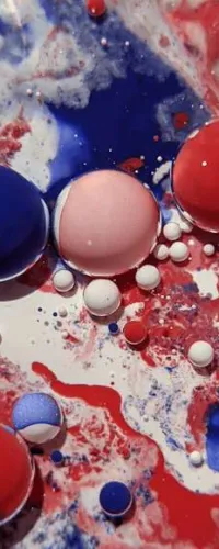 Close-up of red, white, and blue paint droplets and splashes blending on a surface.