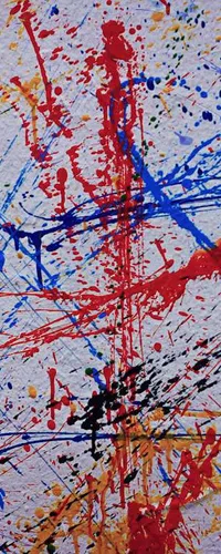 Abstract graffiti wall with vibrant splatters and strokes of red, blue, yellow, black, and green paint.