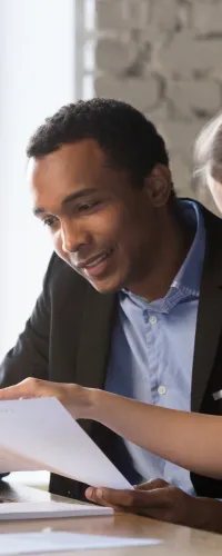 a man and a woman looking at a laptop