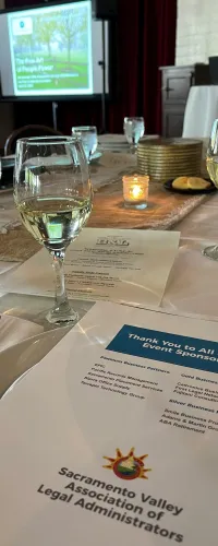 a table with wine glasses and a menu