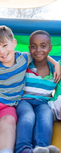 a group of children sitting on a bouncy castle