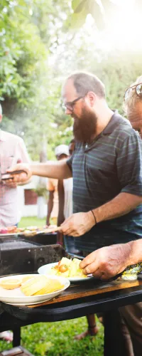 a group of people are eating outside