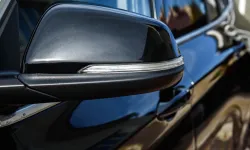 Thumbnail control image for Comparison of a dirty and clean black car side mirror showing before and after cleaning effects.