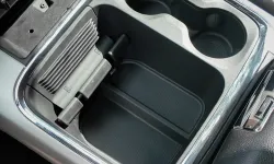 Thumbnail control image for Car center console with dual cup holders and a space for storage between leather seats.