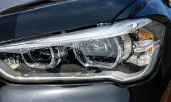 Thumbnail control image for Close-up comparison of a dirty versus clean black car headlight under daylight.