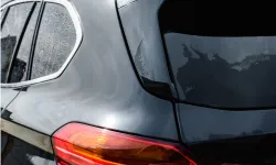 Thumbnail control image for Comparison of dirty and clean black SUV rear windows and taillights under daylight outdoor conditions.