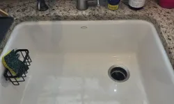 Thumbnail control image for White kitchen sink with silver faucet, Dawn dish soap, hand soap, and a sponge on granite countertop below window.