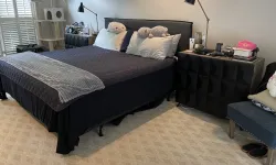 Thumbnail control image for Modern bedroom with black bed, plush pillows, bedside lamps, dark dresser, cat tree, and cozy carpet.