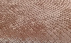Thumbnail control image for Cozy bed with quilted brown blanket and pillows including a decorative home sweet home cushion.