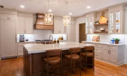 Thumbnail control image for Modern kitchen with large island, leather stools, wooden accents, white cabinets, and elegant pendant lighting.