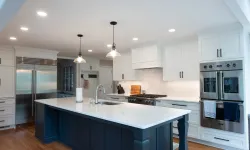 Thumbnail control image for Modern kitchen with large white marble island, navy blue base, stainless steel appliances, and pendant lights.