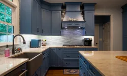 Thumbnail control image for Modern kitchen with blue cabinets, farmhouse sink, light countertops, and decorative backsplash under soft lighting.