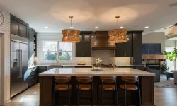 Thumbnail control image for Modern kitchen with dark cabinetry, large island, leather bar stools, and woven pendant lights above.