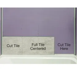 Bathroom wall showing tile placement with instructions for cut and full centered tiles above bathtub edge.
