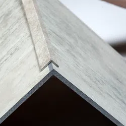 Close-up of a corner joint on a wooden box showing precise interlocking construction details.