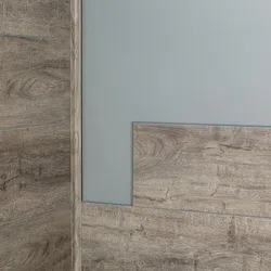 Close-up of rustic wood grain textured wall panels with gray painted wall corner indoors.