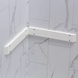 White textured corner handrails mounted on marble tiled walls for bathroom safety support.