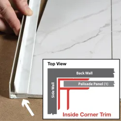 Hand installing white inside corner trim on marble-patterned wall panel with diagram showing trim placement.