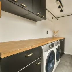 landury room with washer and dryer inside