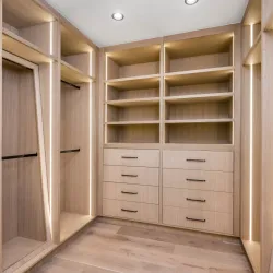 a room with a wood floor and white cabinets