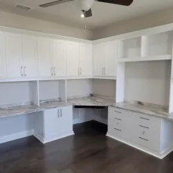 a kitchen with white cabinets