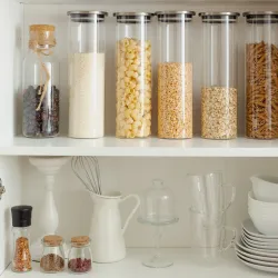 a shelf with glass jars and candles