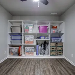 a closet with clothes and shoes