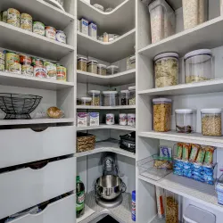 a kitchen with shelves full of food