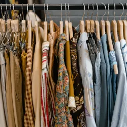 clothes hanging on wooden hangers