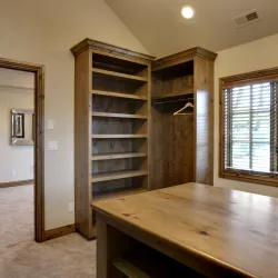 a walk-in with a table and wood shelves