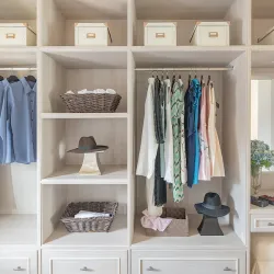 a closet with clothes and hats