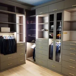 a closet with white cabinets