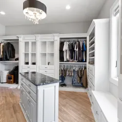 a room with white cabinets and white shelves