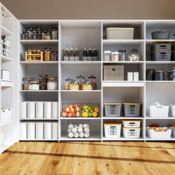 a white shelving unit with many containers of food