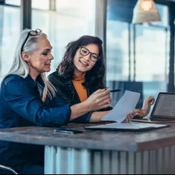 a few women looking at a laptop