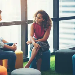 a man and a woman sitting on stools