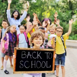 a group of children holding a sign